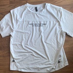 White shirt that say “never lose the power of your spirit “